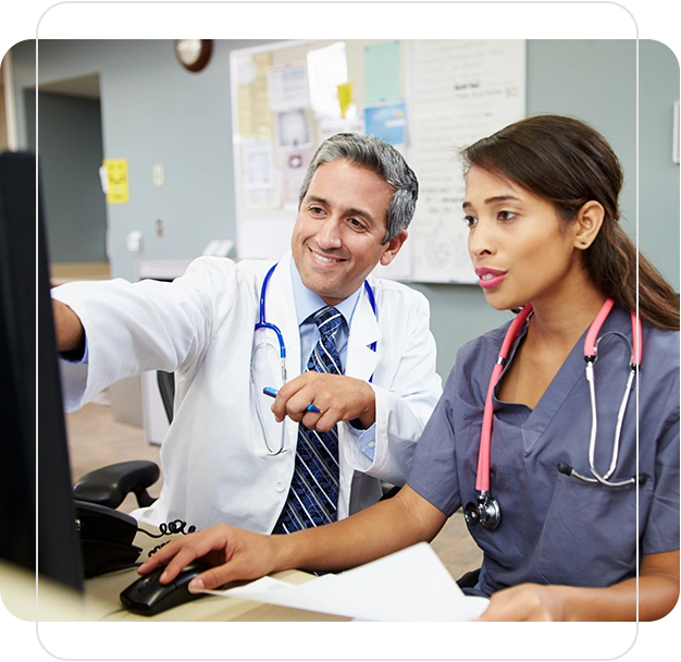 A doctor and nurse are looking at the computer.